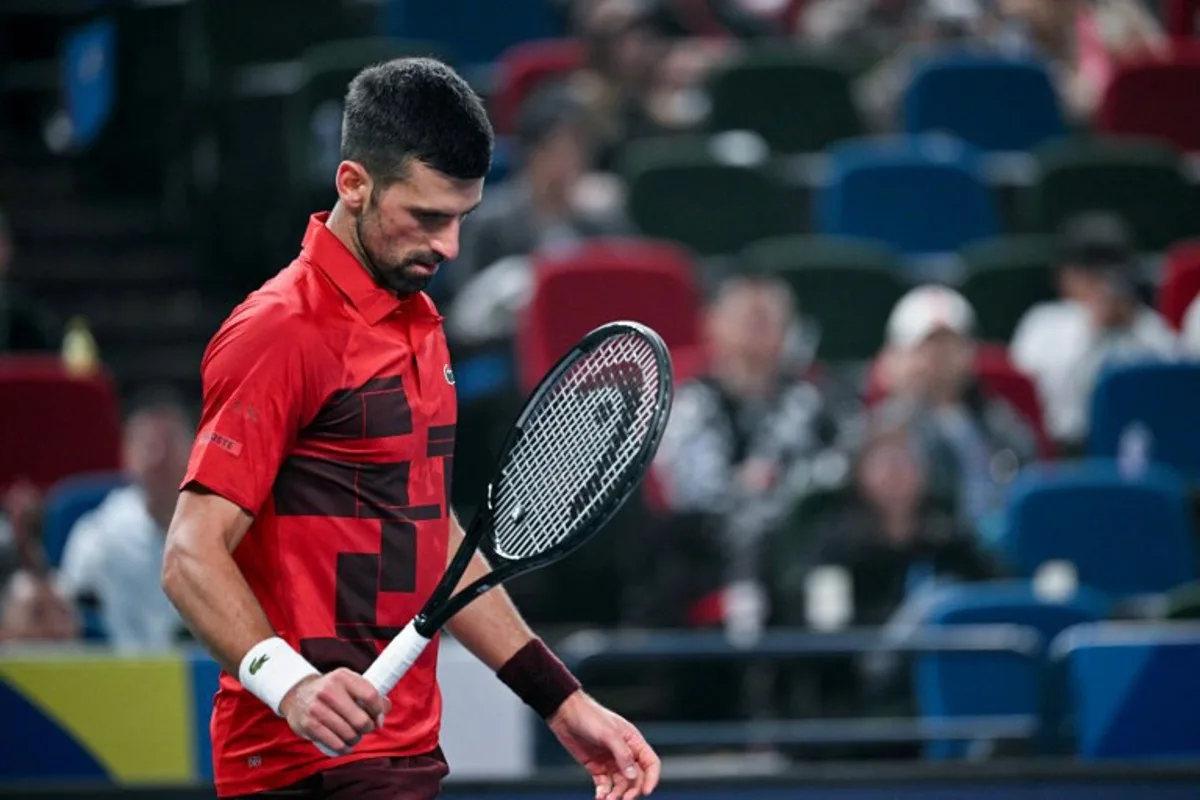 Serbia's Novak Djokovic reacts as he plays against Czech Republic's Jakub Mensik during their men's singles match at the Shanghai Masters tennis tournament in Shanghai on October 11, 2024.  HECTOR RETAMAL / AFP