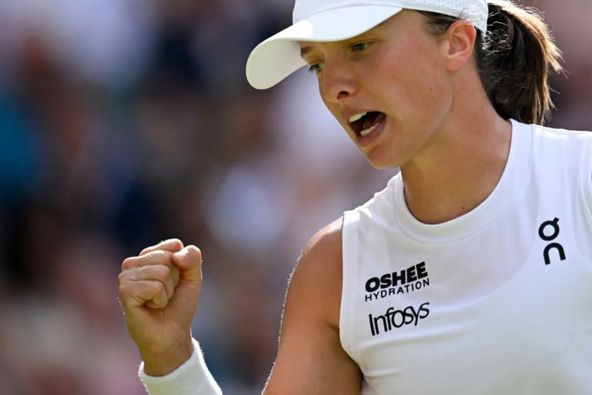 Poland's Iga Swiatek celebrates after winning a point against US player Amanda Anisimova during their women's singles final tennis match on the thirteenth day of the 2025 Wimbledon Championships at The All England Lawn Tennis and Croquet Club in Wimbledon, southwest London, on July 12, 2025. Kirill KUDRYAVTSEV / AFP