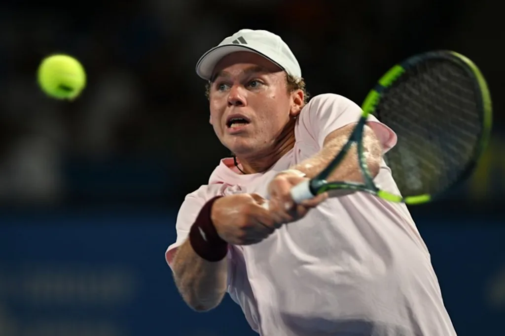 USA's Alex Michelsen plays a shot to Spain's Carlos Alcaraz during their men's singles tennis match at the ATP Tour Japan Open Tennis Championships at the Ariake Tennis Forest Park in Tokyo on October 1, 2026. Rie KIKUCHI / AFP