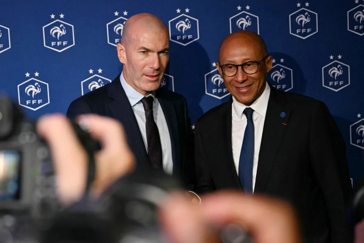 Former French international football player Zinedine Zidane (L) and President of the French Football Federation (FFF) Philippe Diallo (R) pose after a press conference to present him as the new head coach of France national football team at the French Football Federation headquarters (FFF) in Paris on July 28, 2026. The former France playmaker, who won the 1998 World Cup and the 2000 European Championship as a player, has been appointed head coach of the French national team, succeeding Didier Deschamps, the French Football Federation (FFF) announced. Zidane takes over from his former teammate Deschamps, who had been in charge since 2012; Deschamps' tenure ended with a fourth-place finish at the 2026 World Cup, following a title win in 2018 and a final appearance in 2022. LOU BENOIST / AFP