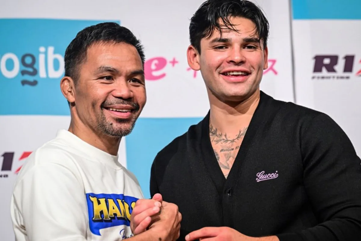 Philippine boxing legend Manny Pacquiao (L) poses with American boxer Ryan Garcia following Pacquiao's official weigh-in at a hotel in Tokyo on July 27, 2024 ahead of his July 28 three-round exhibition boxing match against Japanese mixed martial artist Rukiya Anpo.  Yuichi YAMAZAKI / AFP