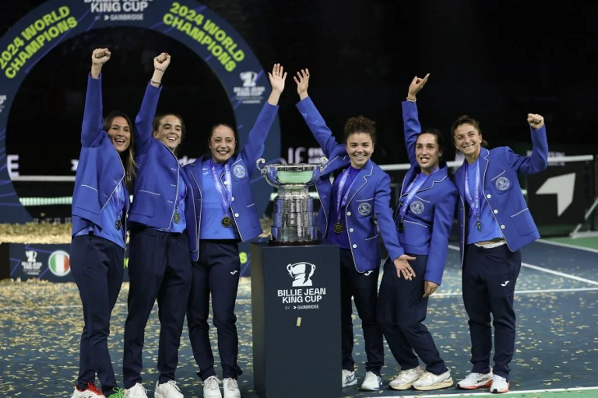 Team Italy poses with the trophy after winning the Billie Jean King Cup Finals at the Palacio de Deportes Jose Maria Martin Carpena arena in Malaga, southern Spain, on November 20, 2024.   Thomas COEX / AFP