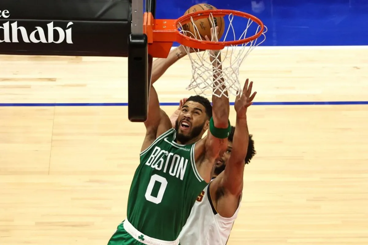 Boston Celtics' forward #0 Jayson Tatum jumps to shoot during the NBA Preseason game between the Boston Celtics and the Denver Nuggets at the Etihad Arena in Abu Dhabi on October 6, 2024.  Fadel Senna / AFP