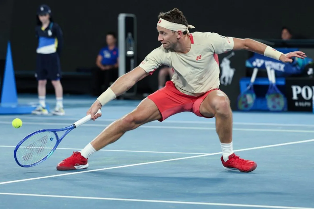 Norway's Casper Ruud hits a return against Spain's Jaume Munar during their men's singles match on day one of the Australian Open tennis tournament in Melbourne on January 12, 2025.   Adrian DENNIS / AFP