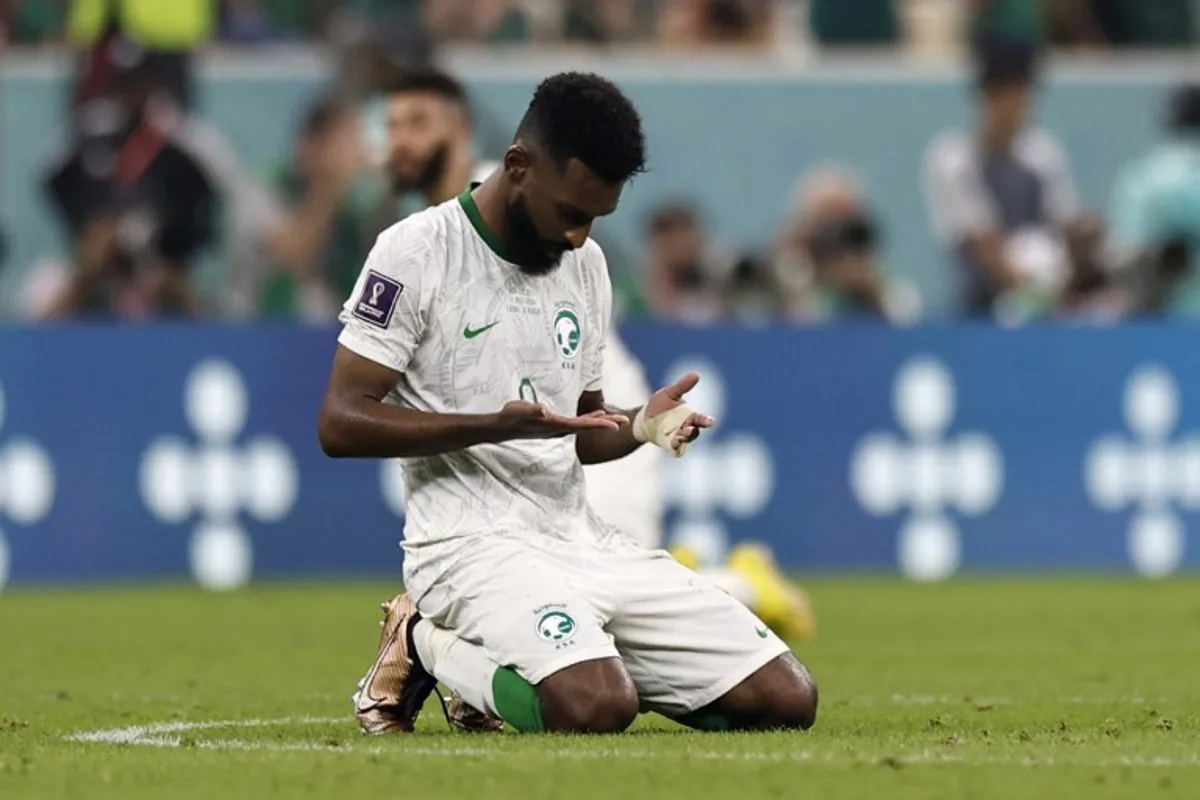 Saudi Arabia's forward #09 Firas Al-Buraikan kneels at the end of the Qatar 2022 World Cup Group C football match between Saudi Arabia and Mexico at the Lusail Stadium in Lusail, north of Doha on November 30, 2022. Khaled DESOUKI / AFP