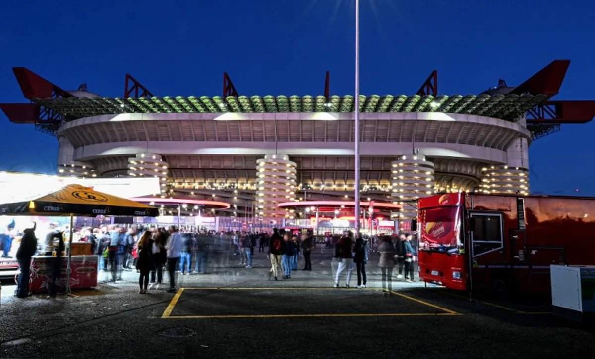 This slow shutter speed exposure image shows food tracks selling assorted food outside the stadium prior to the Italian Serie A football match between AC Milan and Pisa SC at San Siro stadium in Milan, northern Italy, on October 24, 2025. Stefano RELLANDINI / AFP
