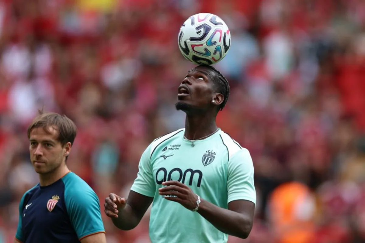 Monaco's French midfielder #08 Paul Pogba on the pitch ahead of the pre-season friendly football match between Liverpool and Monaco at Anfield in Liverpool, north west England on August 9, 2026. Darren Staples / AFP