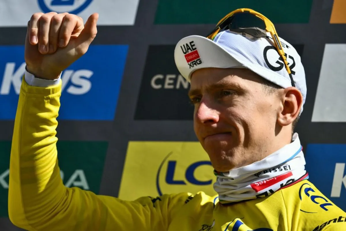 UAE Team Emirates - XRG team's Slovenian rider Tadej Pogacar celebrates on the podium with the overall leader's yellow jersey after the 16th stage of the 112th edition of the Tour de France cycling race, 171.5 km between Montpellier and Mont Ventoux, southern France, on July 22, 2025. Marco BERTORELLO / AFP