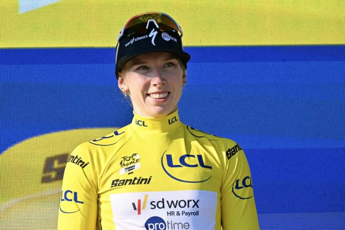 Yellow jersey of overall leader Team SD Worx-Protime's Dutch rider Lorena Wiebes poses on the podium after she won the first (out of 9) stage of the fifth edition of the Women's Tour de France cycling race, 138 km from Lausanne to Lausanne on August 1, 2026. NICOLAS TUCAT / AFP