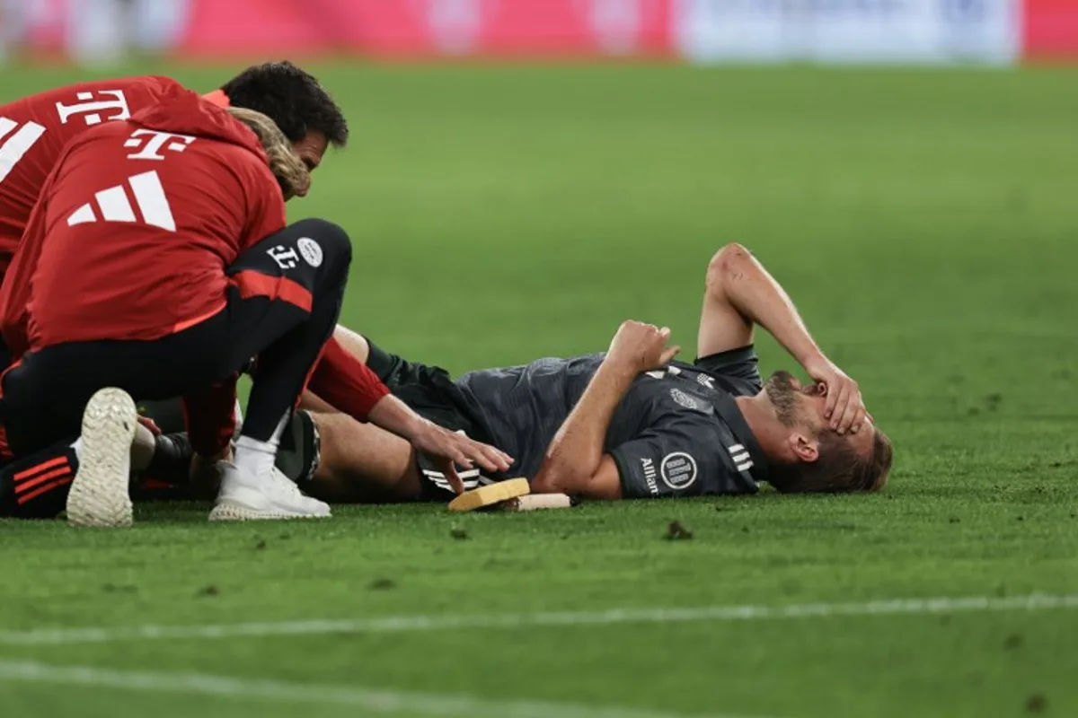 Bayern Munich's English forward #09 Harry Kane reacts injured on the ground during the German first division Bundesliga football match between FC Bayern Munich and Bayer 04 Leverkusen in Munich, southern Germany on September 28, 2024.  Alexandra BEIER / AFP