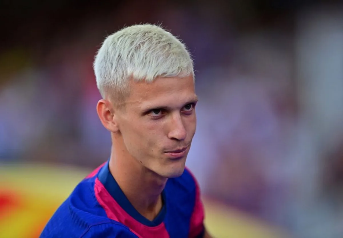 Barcelona's Spanish midfielder #20 Dani Olmo looks on during his presentation prior the 59th Joan Gamper Trophy football match between FC Barcelona and AS Monaco at the Estadi Olimpic Lluis Companys in Barcelona on August 12, 2024.  MANAURE QUINTERO / AFP