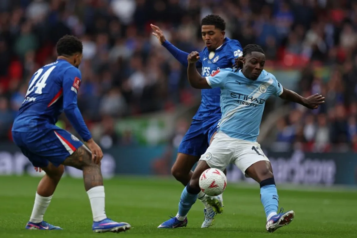Manchester City's Belgian midfielder #11 Jeremy Doku (R) vies with Chelsea's English defender #24 Reece James (L) and Chelsea's French defender #29 Wesley Fofana (C) during the English FA Cup final football match between Chelsea and Manchester City at Wembley stadium in London, on May 16, 2026. Adrian Dennis / AFP