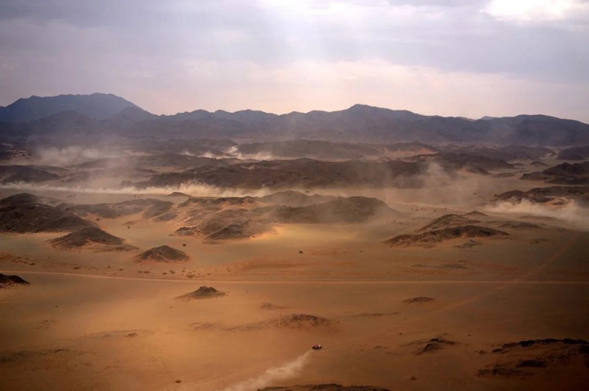 Competitors drive their cars during Stage 7 of the Dakar Rally 2025, between Al Duwadimi and Al Duwadimi, Saudi Arabia, on January 12, 2025.  Valery HACHE / AFP