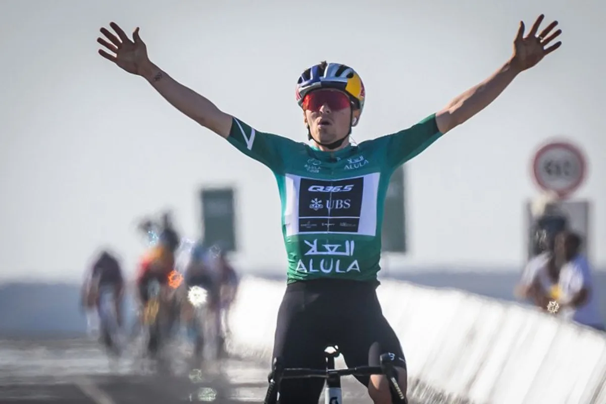 Team Q36.5 Pro Cycling's British rider Tom Pidcock celebrates as he crosses the finish line to win the fourth stage of the AlUla Tour cycling race, from Maraya to skyviews of Hattat Uwayrid, on January 31, 2025.  Loic VENANCE / AFP