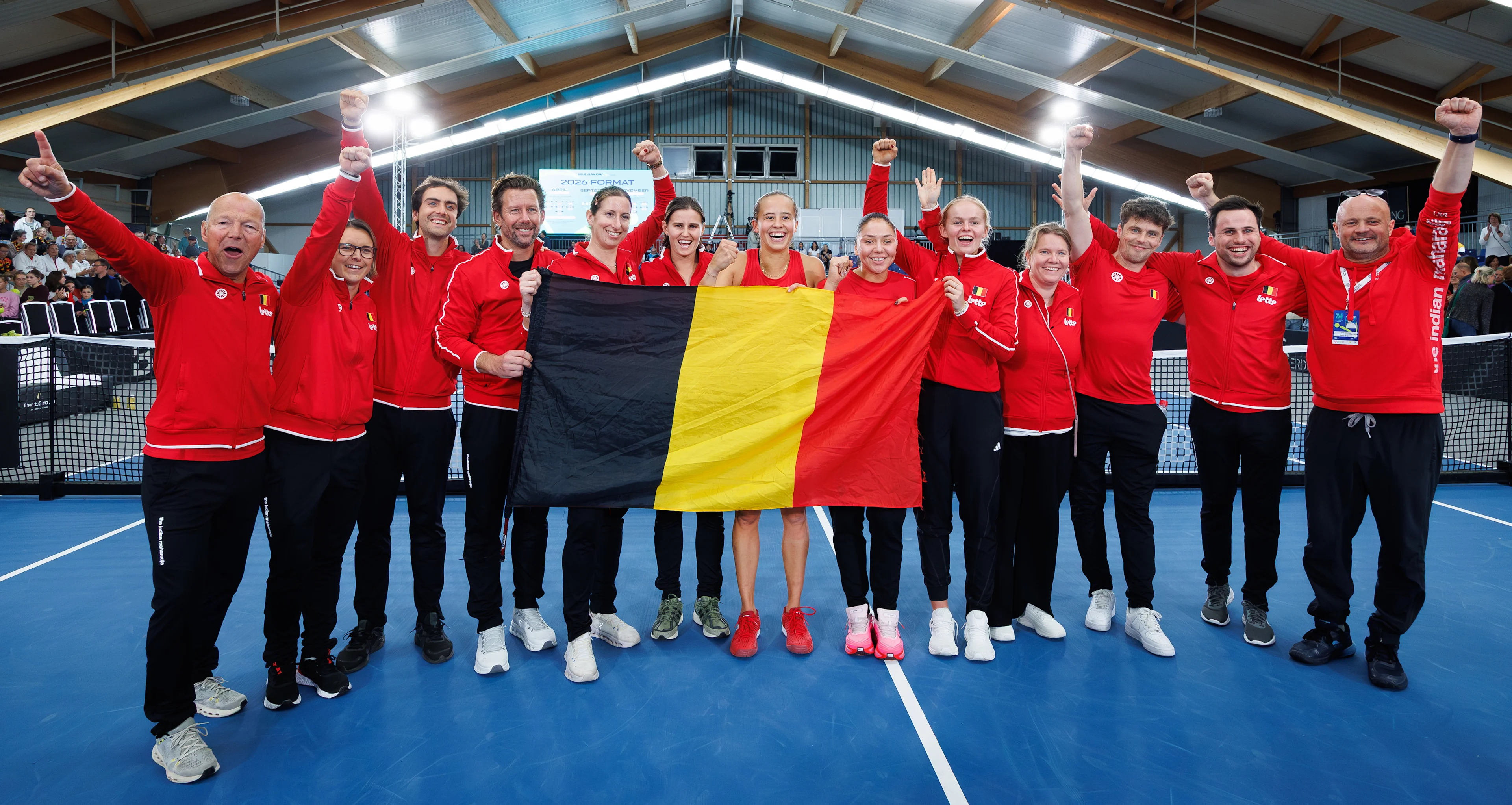 Belgium's players and staff celebrate after a tennis match between Belgian Vandewinkel and German Seidel, the second match of the meeting between Belgium and Germany in the Billie Jean King Cup Play-offs, on Sunday 16 November 2025 in Ismaning, Germany. PHOTO BENOIT DOPPAGNE