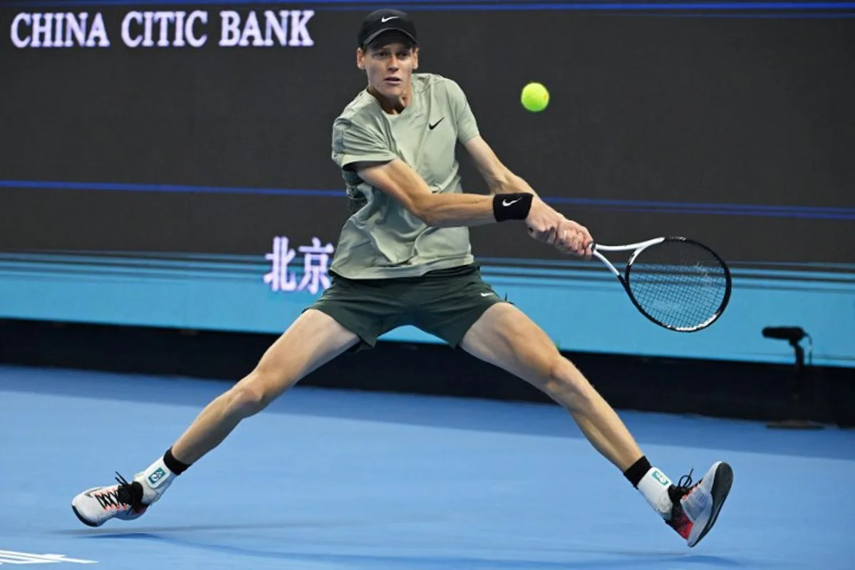 Italy's Jannik Sinner hits a return to Spain's Carlos Alcaraz during the men's singles final at the China Open tennis tournament in Beijing on October 2, 2024.  GREG BAKER / AFP