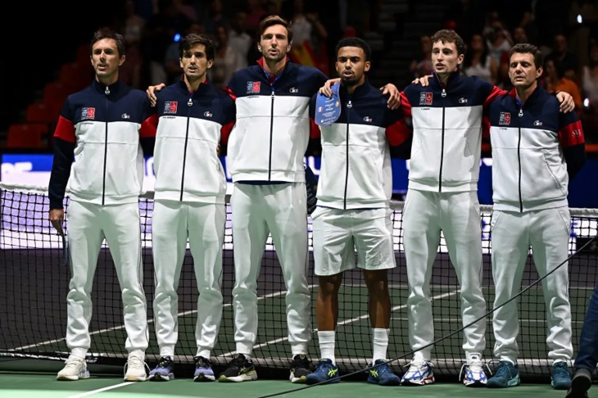 (From L) France's Edouard Roger-Vasselin, France's Pierre-Hugues Herbert, France's Arthur Rinderknech, France's Arthur Fils, France's Ugo Humbert and France's Paul-Henri Mathieu line up before the group stage men's singles match between France and Spain of the Davis Cup tennis tournament at the Fuente San Luis Sports Hall in Valencia on September 13, 2024. Jose Jordan / AFP