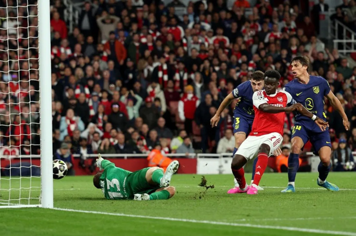 Arsenal's English midfielder #07 Bukayo Saka scores the team's first goal during the UEFA Champions League second-leg semi-final football match between Arsenal and Atletico Madrid at the Emirates Stadium in north London on May 5, 2026.  Adrian Dennis / AFP