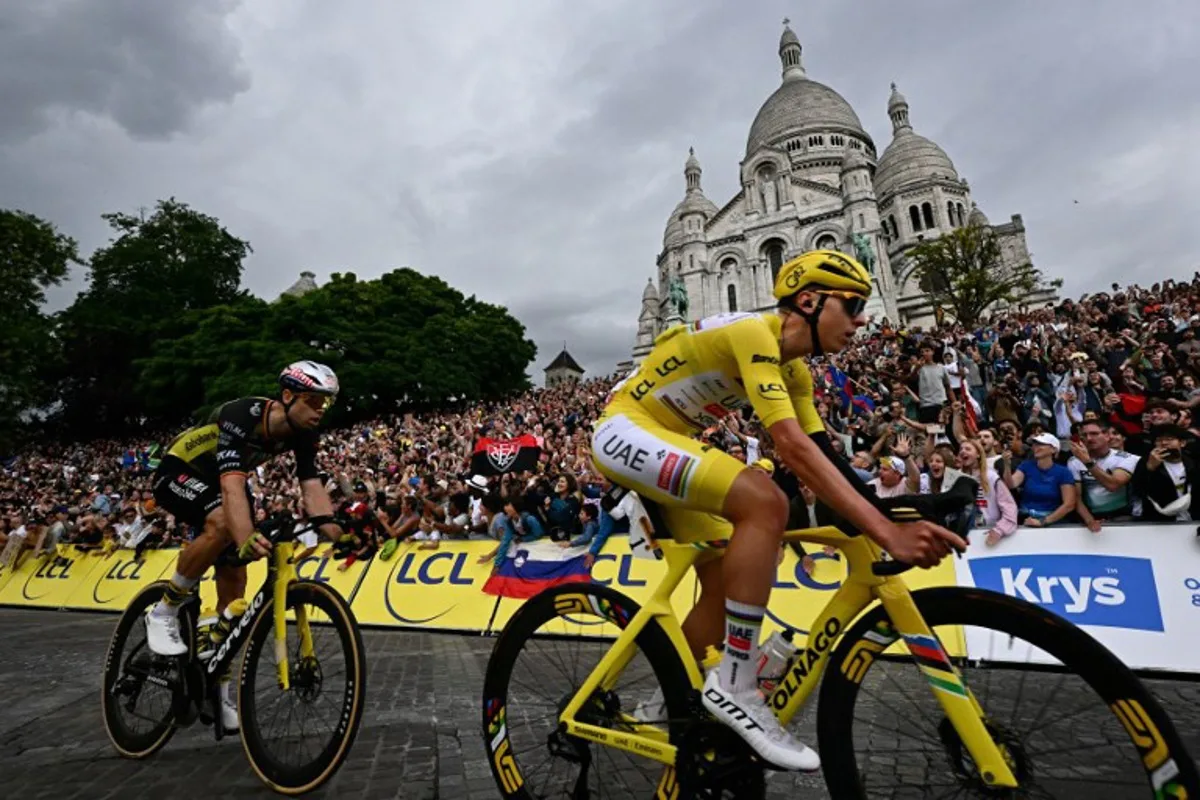 UAE Team Emirates - XRG team's Slovenian rider Tadej Pogacar wearing the overall leader's yellow jersey and Team Visma - Lease a bike team's Belgian rider Wout van Aert cycle past the Sacre-Coeur Basilica on the Butte de Montmartre during the 21st and final stage of the 112th edition of the Tour de France cycling race, 132.3 km between Mantes-la-Ville and Paris' Champs-Elysees Avenue, on July 27, 2025. Loic VENANCE / AFP