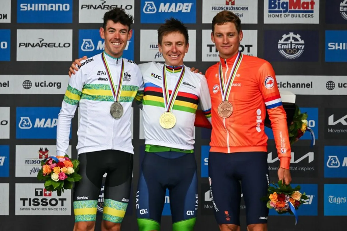 (From L) Second-placed Australia's Ben O'Connor, winner Slovenia's Tadej Pogacar and third-placed Netherlands' Mathieu van der Poel celebrate during the podium ceremony of the men's Elite Road Race cycling event as part of the UCI 2024 Road World Championships, in Zurich, on September 29, 2024.  Fabrice COFFRINI / AFP