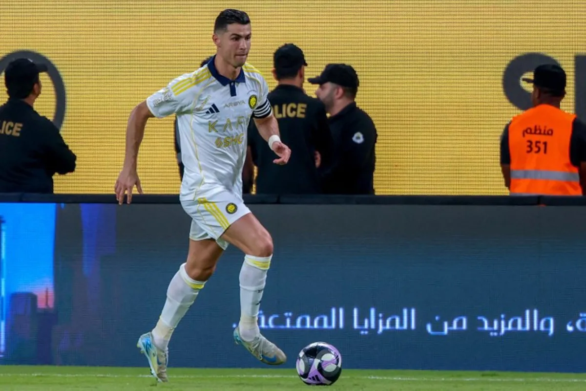 Nassr's Portuguese forward #7 Cristiano Ronaldo runs with the ball during the Saudi Pro League football match between Al-Nassr and Al-Khaleej at Al-Awwal Park in Riyadh on May 21, 2025. Fayez NURELDINE / AFP