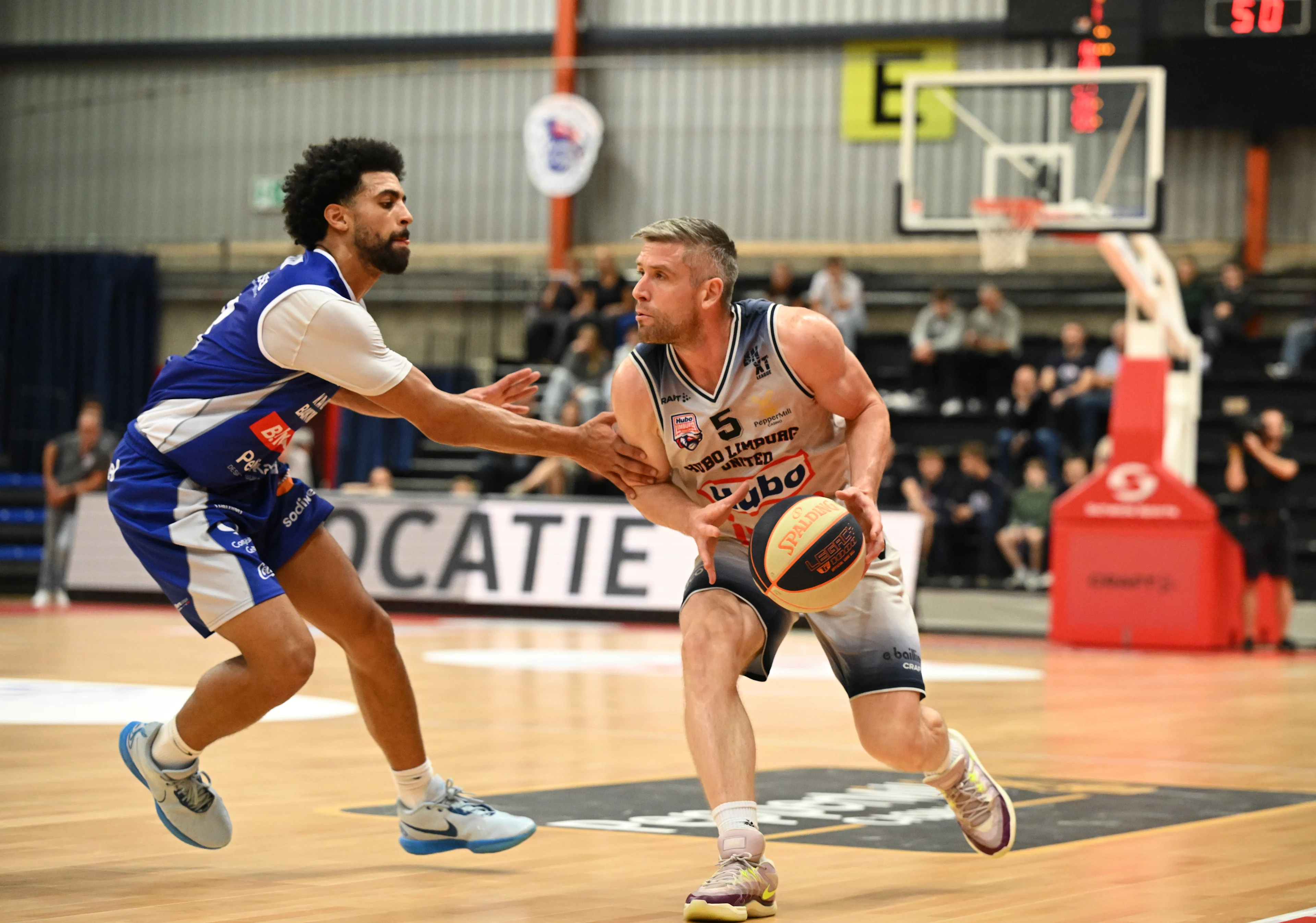 Mechelen's Trenton Gibson and Limburg's Quentin Serron fight for the ball during a basketball match between Limburg United and Kangoeroes Mechelen, Friday 20 September 2024 in Hasselt, on day 2 of the 'BNXT League' Belgian/ Dutch first division basket championship. BELGA PHOTO JOHN THYS