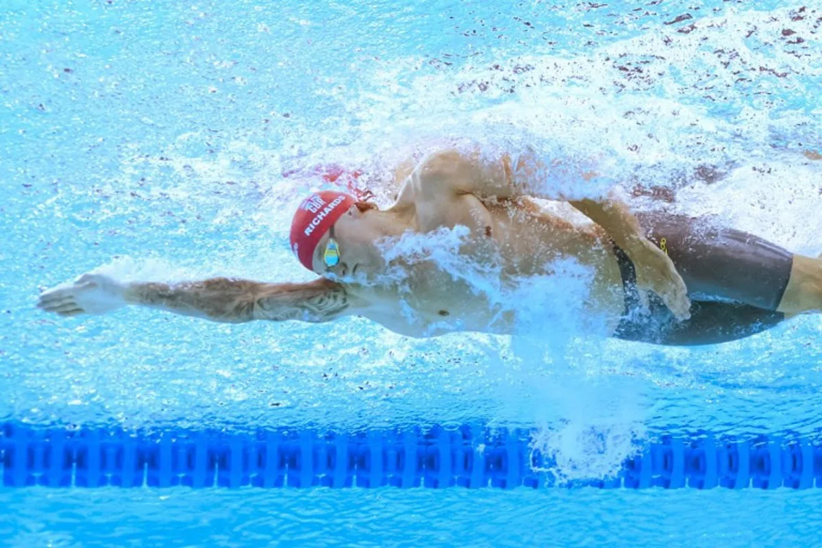 An underwater view shows Britain's swimmer Matthew Richards as he competes in a heat of the men's 100m freestyle swimming event during the 2025 World Aquatics Championships in Singapore on July 30, 2025. FRANCOIS-XAVIER MARIT / AFP