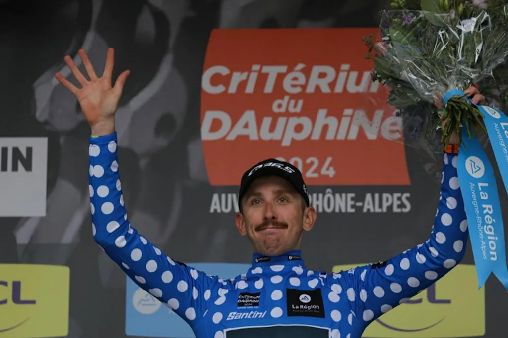 Team Q36.5's British rider Mark Donovan wearing the best climber's dotted jersey celebrates on the podium after the first stage of the 76th edition of the Criterium du Dauphine cycling race, 172,5km between in Saint-Pourcain-sur-Sioule, central France, on June 2, 2024. Thomas SAMSON / AFP