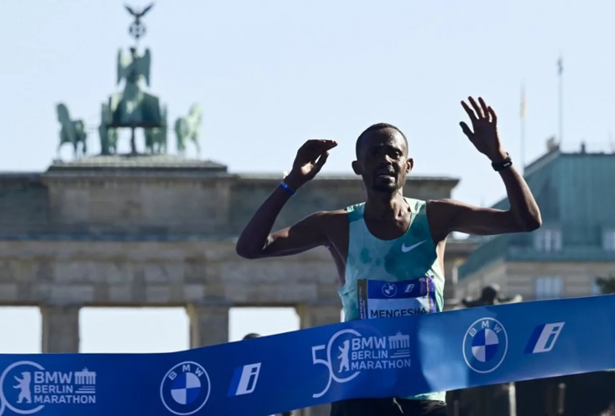 Ethiopia's Milkesa Mengesha crosses the finish line to win the 50th edition of the Berlin Marathon in Berlin, Germany on September 29, 2024.  John MACDOUGALL / AFP