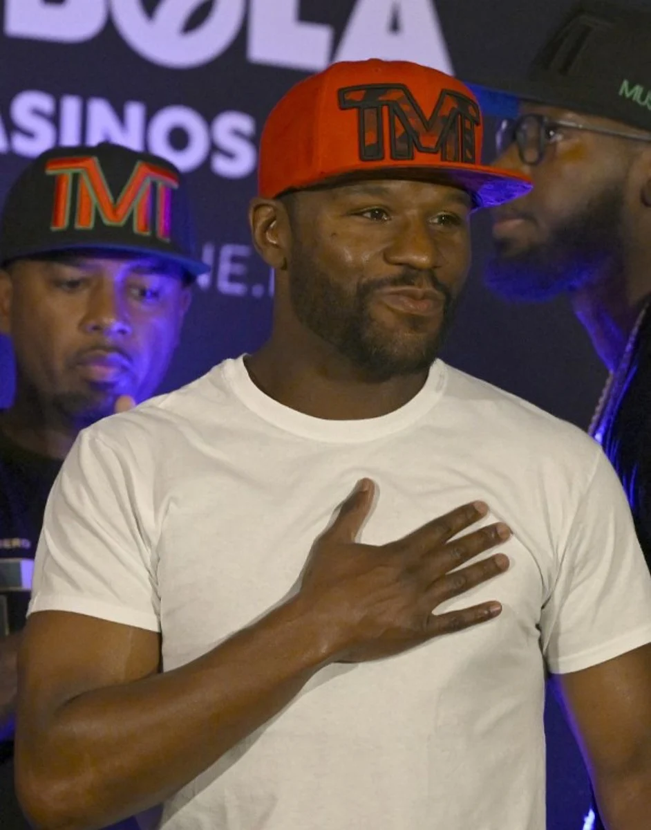 US boxer Floyd Mayweather Jr. gestures during the weighing ceremony for his upcoming exhibition fight against John Gutti III in Mexico City on August 23, 2024. Mayweather Jr. and Gotti III will face each other in an exhibition fight in Mexico on August 24, 2024. ALFREDO ESTRELLA / AFP