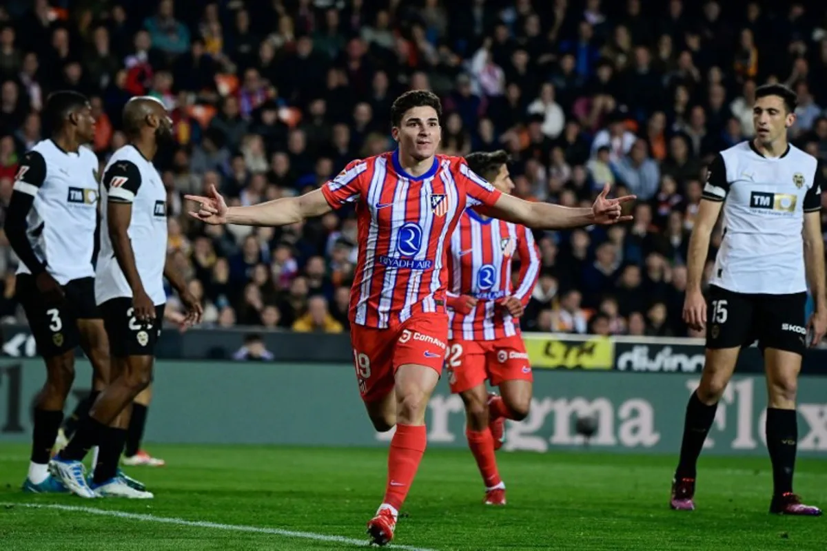 Atletico Madrid's Argentine forward #19 Julian Alvarez celebrates after scoring their first goal during the Spanish league football match between Valencia CF and Club Atletico de Madrid at Mestalla Stadium in Valencia on February 22, 2025.  JOSE JORDAN / AFP