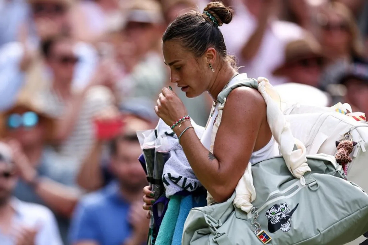 Belarus's Aryna Sabalenka reacts as she leaves Centre Court following her defeat against US player Amanda Anisimova during their women's singles semi-final tennis match on the eleventh day of the 2025 Wimbledon Championships at The All England Lawn Tennis and Croquet Club in Wimbledon, southwest London, on July 10, 2025. HENRY NICHOLLS / AFP