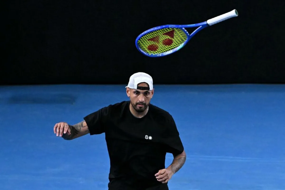Australia's Nick Kyrgios throws his racket during his men's doubles match against compatriot Jason Kubler and Marc Polmans on day five of the Australian Open tennis tournament in Melbourne on January 22, 2026. WILLIAM WEST / AFP