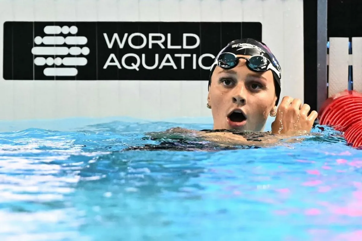 Canada's swimmer Summer Mcintosh reacts after winning the final of the women's 400m freestyle swimming event during the 2025 World Aquatics Championships in Singapore on July 27, 2025. MANAN VATSYAYANA / AFP