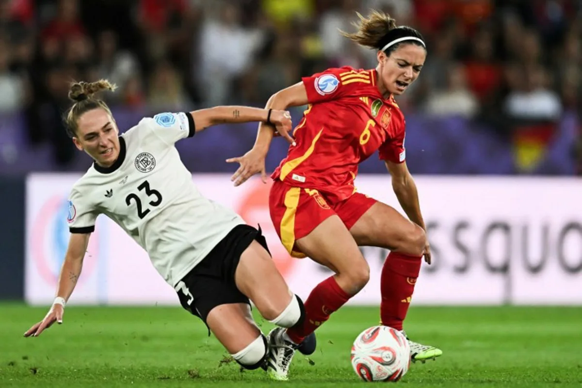 Spain's midfielder #06 Aitana Bonmati (R) and Germany's defender #23 Sophia Kleinherne (L) fight for the ball during the UEFA Women's Euro 2025 semi-final football match between Germany and Spain at the Letzigrund Stadium in Zurich, on July 23, 2025. Fabrice COFFRINI / AFP