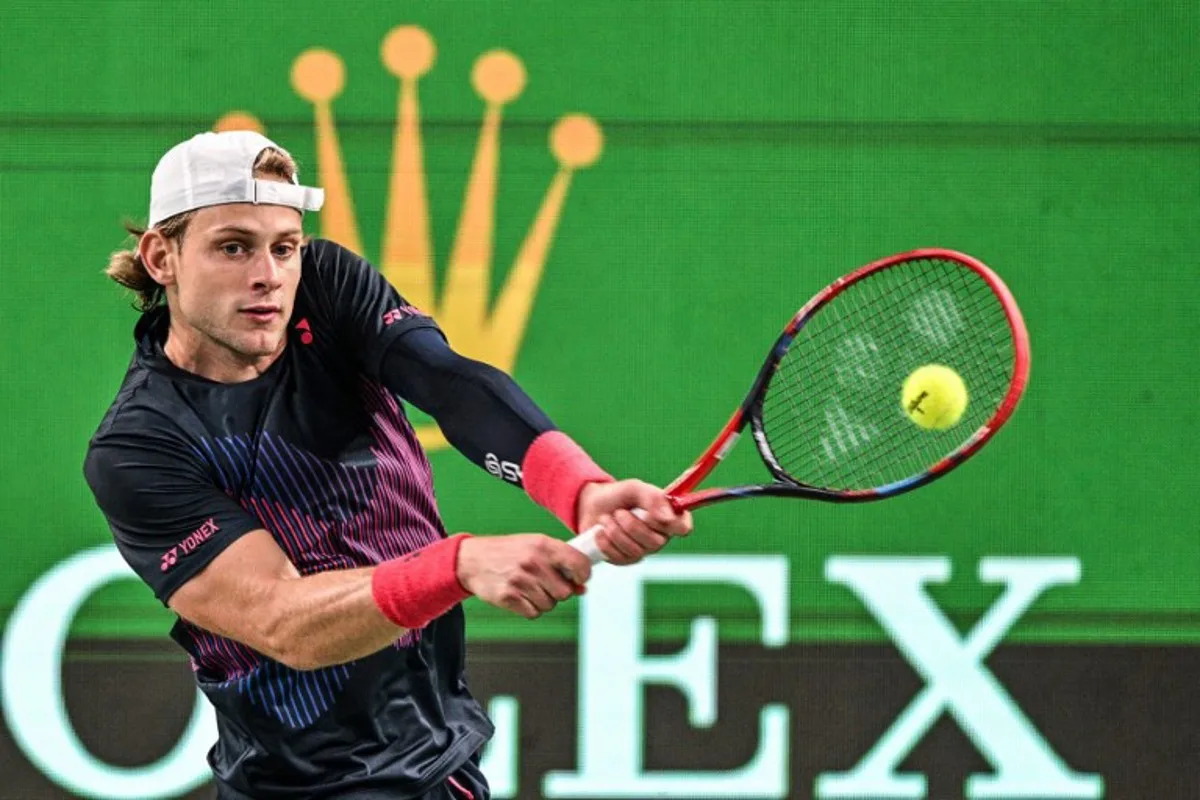 Belgium's Zizou Bergs hits a return to China's Zhizhen Zhang during their men's singles match at the Shanghai Masters tennis tournament in Shanghai on October 3, 2024.  Hector RETAMAL / AFP