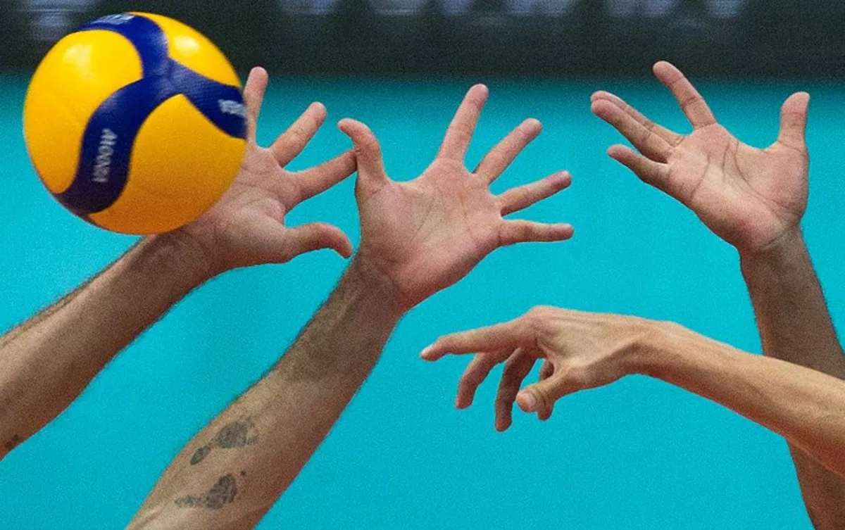 Italy's Gianelli (R) spikes the ball as Brazil's Lucas Saatkamp (L) tries to block him during their pool A volleyball Olympic qualifier match, in Rio de Janeiro, Brazil, on October 8, 2023.  DANIEL RAMALHO / AFP