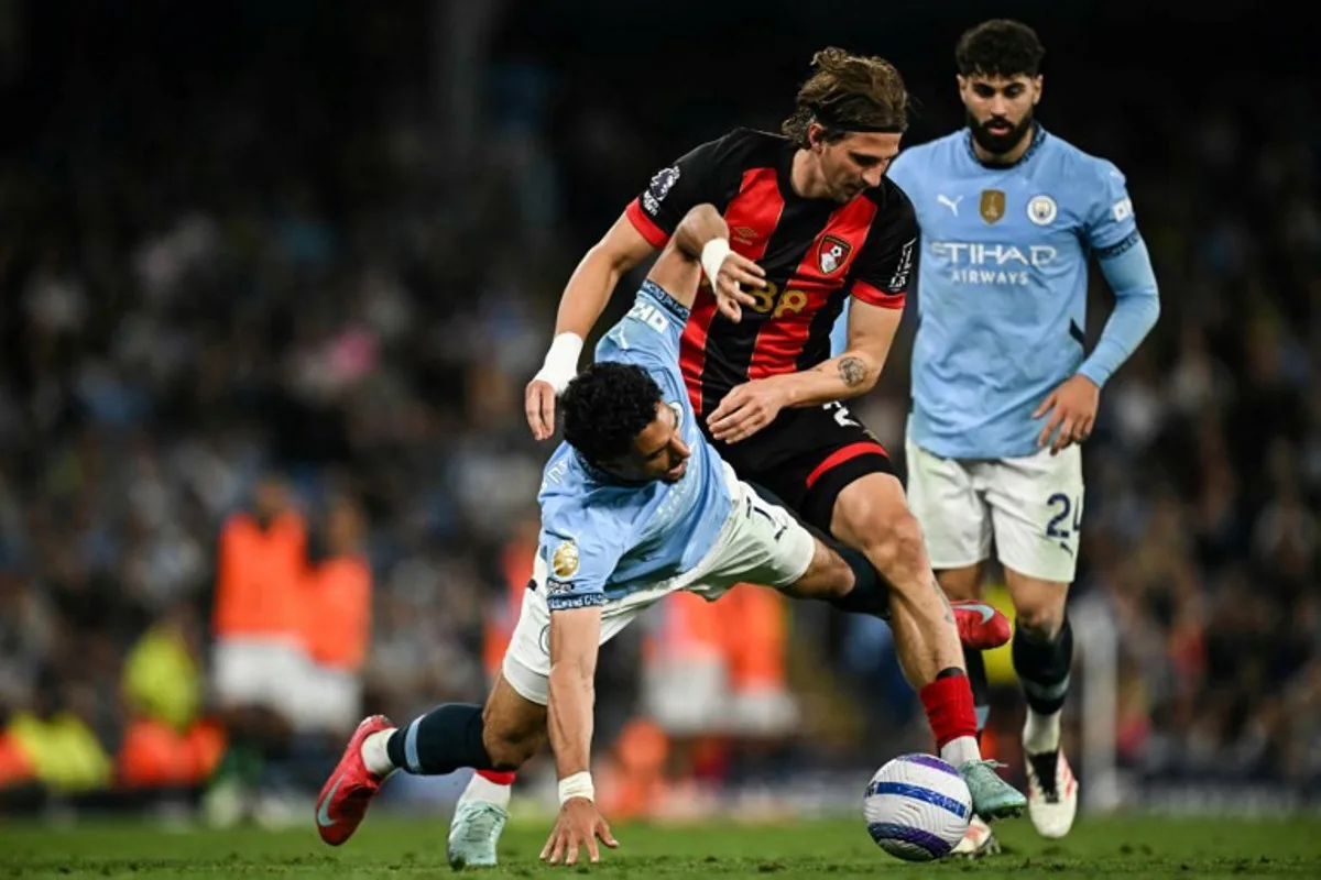 Manchester City's Egyptian striker #07 Omar Marmoush (L) fights for the ball with Bournemouth's Ukrainian defender #27 Illia Zabarnyi (C) during the English Premier League football match between Manchester City and Bournemouth at the Etihad Stadium in Manchester, north west England, on May 20, 2025. Paul ELLIS / AFP