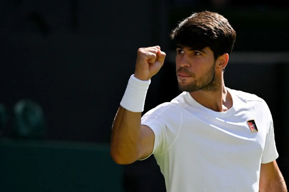 Spain's Carlos Alcaraz celebrates winning the third set against US player Taylor Fritz during their men's singles semi-final tennis match on the twelfth day of the 2025 Wimbledon Championships at The All England Lawn Tennis and Croquet Club in Wimbledon, southwest London, on July 11, 2025. Glyn KIRK / AFP