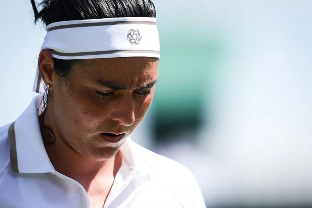 Tunisia's Ons Jabeur reacts as she plays against Bulgaria's Viktoriya Tomova during their women's singles first round tennis match on the first day of the 2025 Wimbledon Championships at The All England Lawn Tennis and Croquet Club in Wimbledon, southwest London, on June 30, 2025. HENRY NICHOLLS / AFP