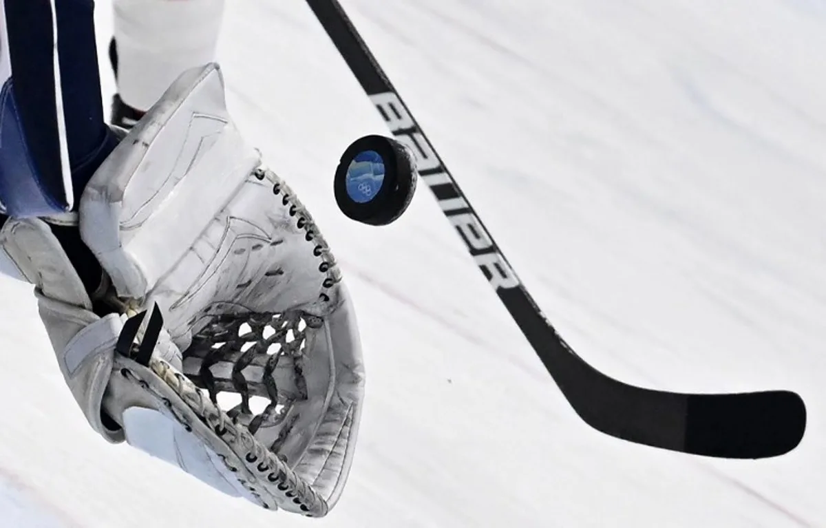 Finland's goaltender Harri Sateri catches the puck during the men's play-off quarterfinal match of the Beijing 2022 Winter Olympic Games ice hockey competition against Switzerland, at the National Indoor Stadium in Beijing on February 16, 2022. ANTHONY WALLACE / AFP