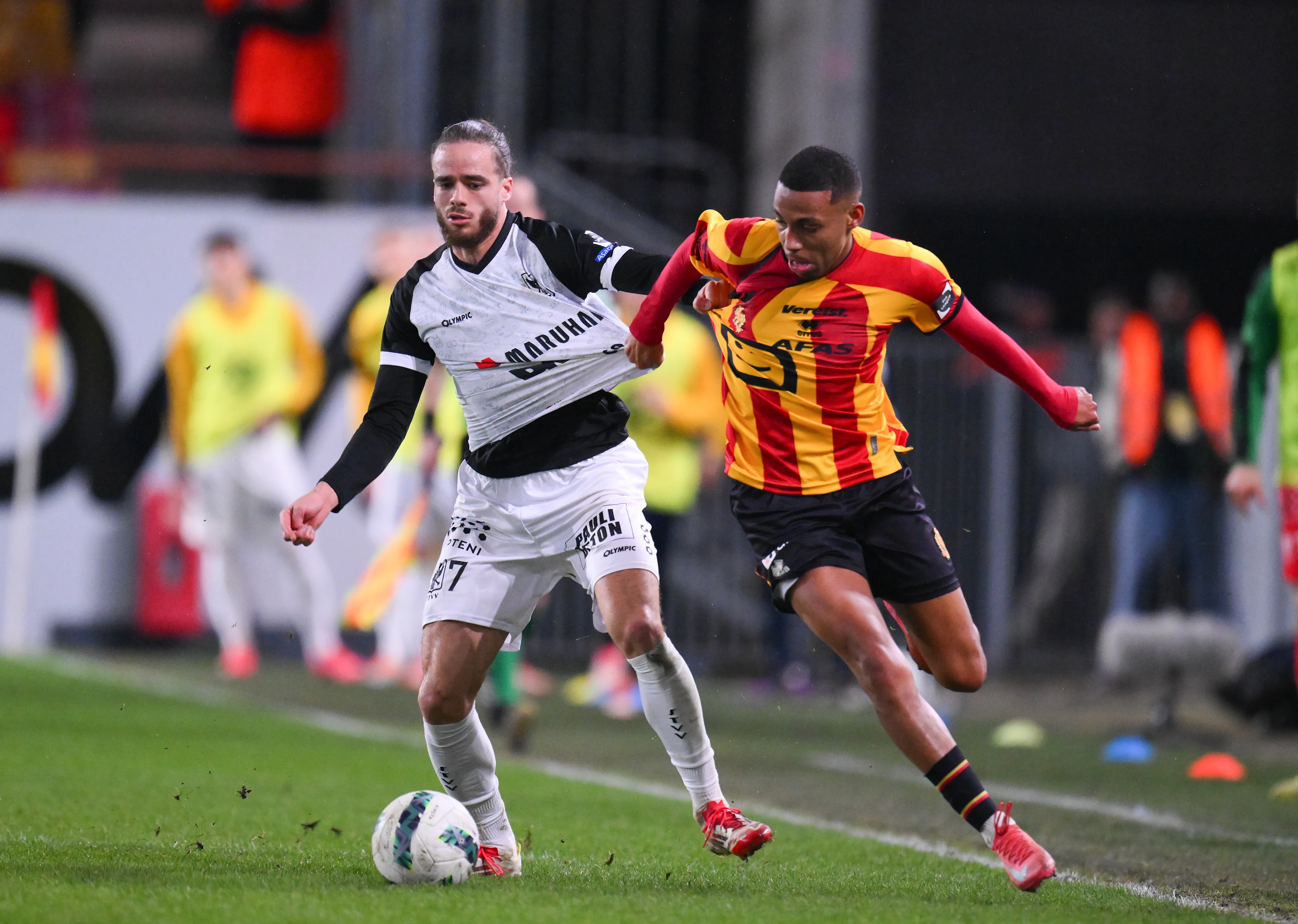 STVV's Matt Lendfers and Mechelen's Rafik Belghali fight for the ball during a soccer match between KV Mechelen and Sint-Truiden VV, Friday 21 February 2025 in Mechelen, on day 27 of the 2024-2025 season of the 'Jupiler Pro League' first division of the Belgian championship. BELGA PHOTO JOHN THYS