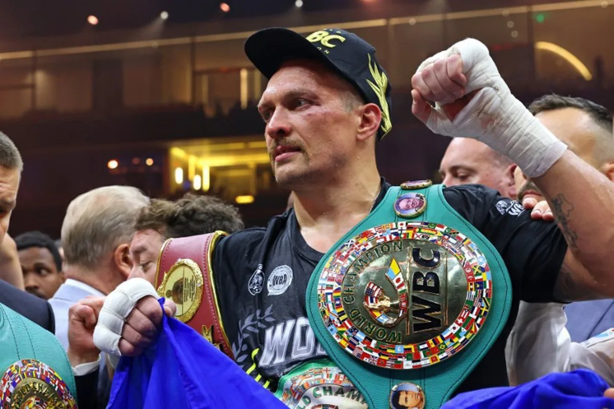 Ukraine's Oleksandr Usyk (C) celebrates his victory over Britain's Tyson Fury during a heavyweight boxing world championship fight at Kingdom Arena in Riyadh, Saudi Arabia on May 19, 2024.  Oleksandr Usyk beat Tyson Fury by split decision to win the world's first undisputed heavyweight championship in 25 years on May 19, 2024, an unprecedented feat in boxing's four-belt era. Fayez NURELDINE / AFP