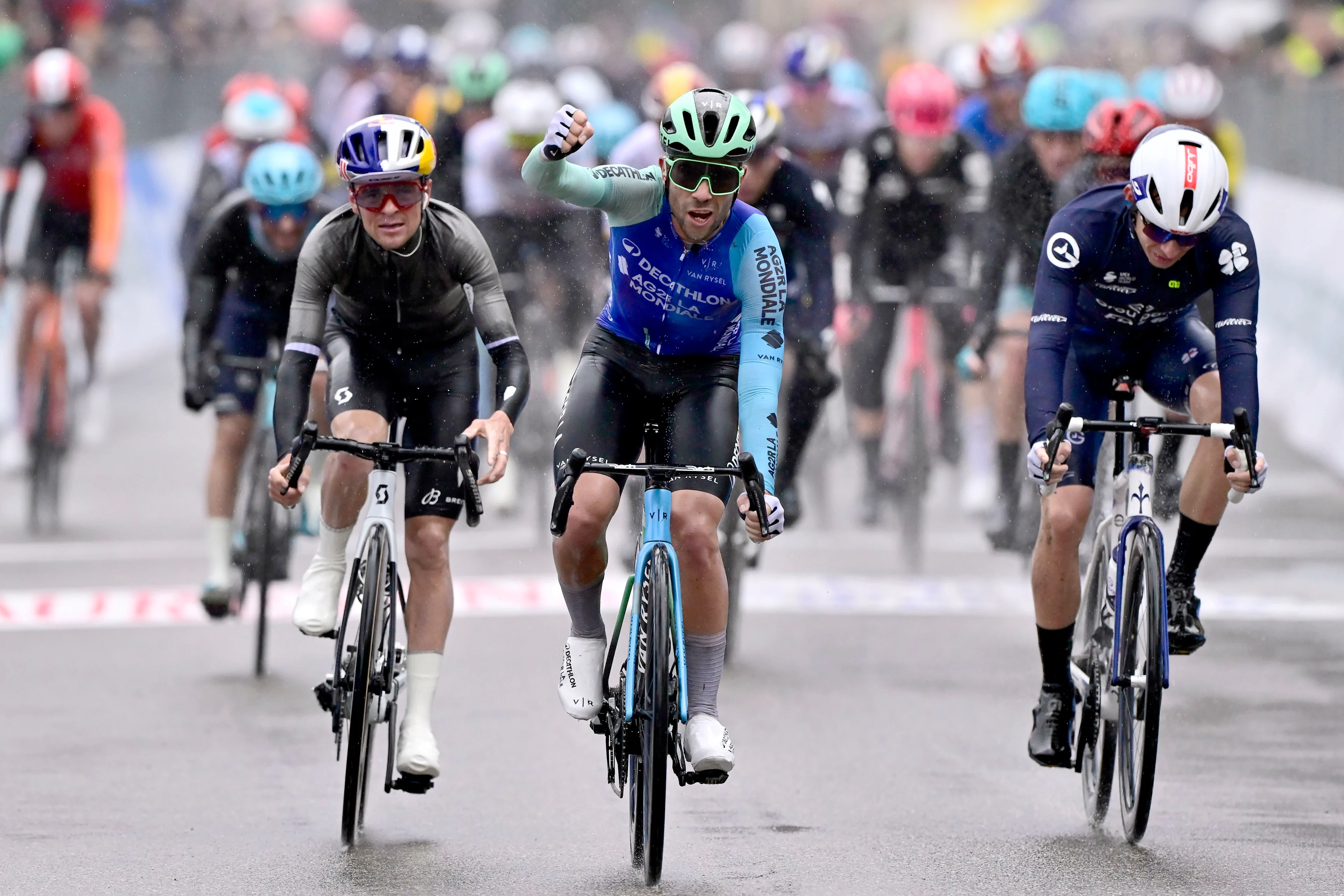 Italian Andrea Vendrame of Decathlon AG2R La Mondiale Team (C) celebrates after winning the third stage of the Tirreno-Adriatico cycling race, a 239km race from Follonica to Colfiorito (Foligno), Italy, Wednesday 12 March 2025. BELGA PHOTO DIRK WAEM