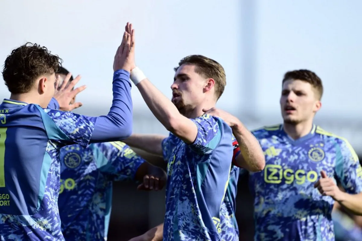 Mika Godts of Ajax (L) and Kenneth Taylor of Ajax (C) celebrate the 0-1 during the Dutch Eredivisie football match between Almere City FC and AFC Ajax at Almere City FC Stadium in Almere, on March 2, 2025.  Olaf Kraak / ANP / AFP