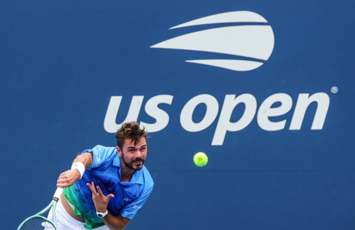 Switzerland's Stan Wawrinka serves to Italy's Matteo Berrettini in their men's singles first round tennis match on day two of the US Open tennis tournament at the USTA Billie Jean King National Tennis Center in New York City on August 31, 2026.  KENA BETANCUR / AFP