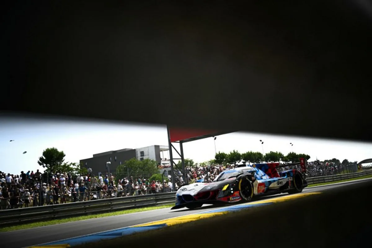 This photograph shows BMW M Team WRT's car driven by Danish Kevin Magnussen, Italian Raffaele Marciello and Belgian Dries Vanthoor during the 94th edition of the 24 Hours of Le Mans at the Le Mans circuit, north-western France on June 13, 2026.  Lou BENOIST / AFP