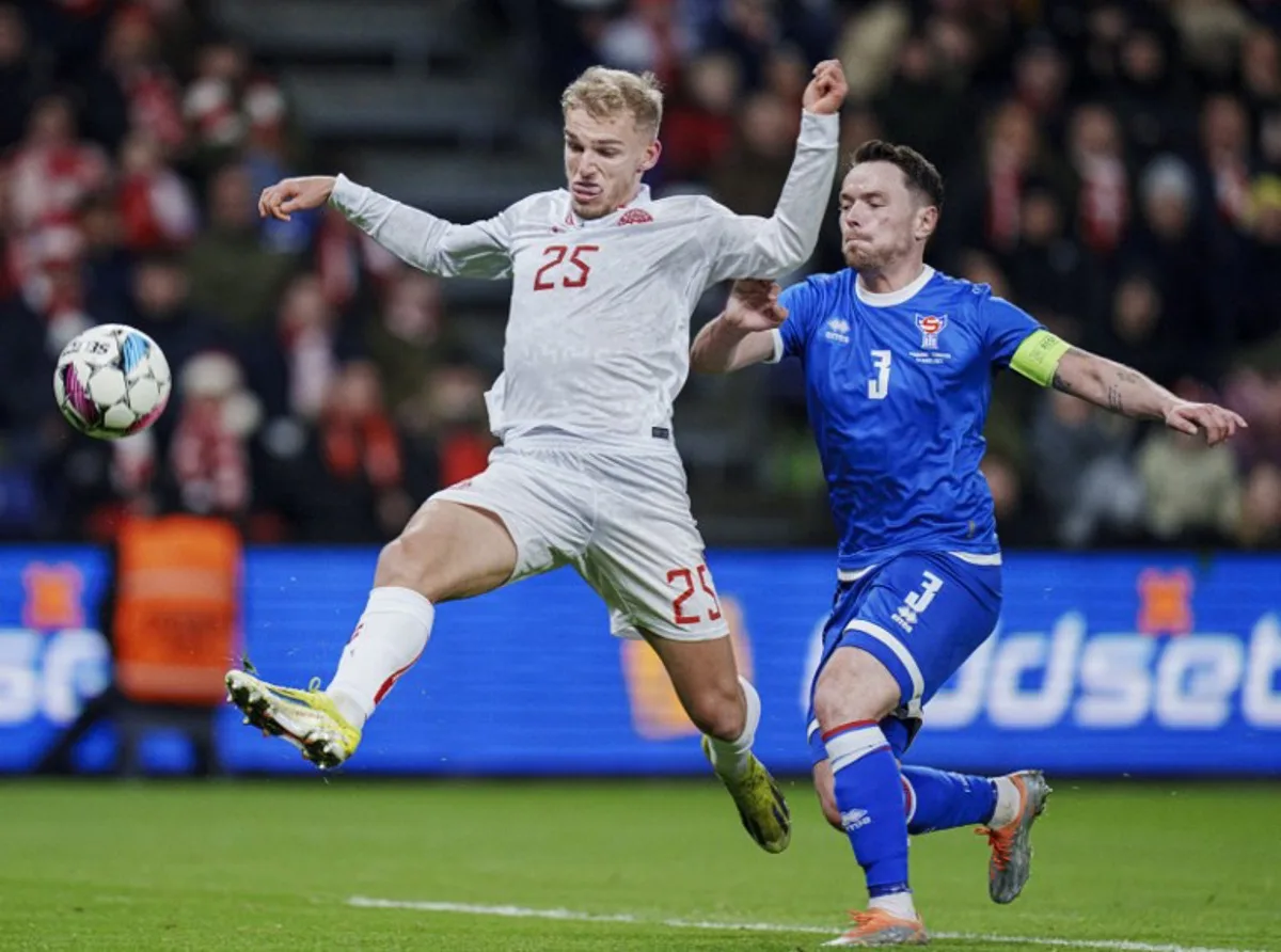 Denmark's Gustav Isaksen and the Faroe Islands' Viljormur Davidsen vie for the ball during the friendly football match between Denmark and Faroe Islands in Brondby Stadion near Copenhagen, Denmark, on March 26, 2024.  Liselotte Sabroe / Ritzau Scanpix / AFP