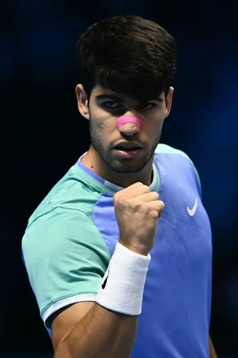 Spain's Carlos Alcaraz reacts during his match against Germany's Alexander Zverev at the ATP Finals tennis tournament in Turin on November 15, 2024.  Marco BERTORELLO / AFP