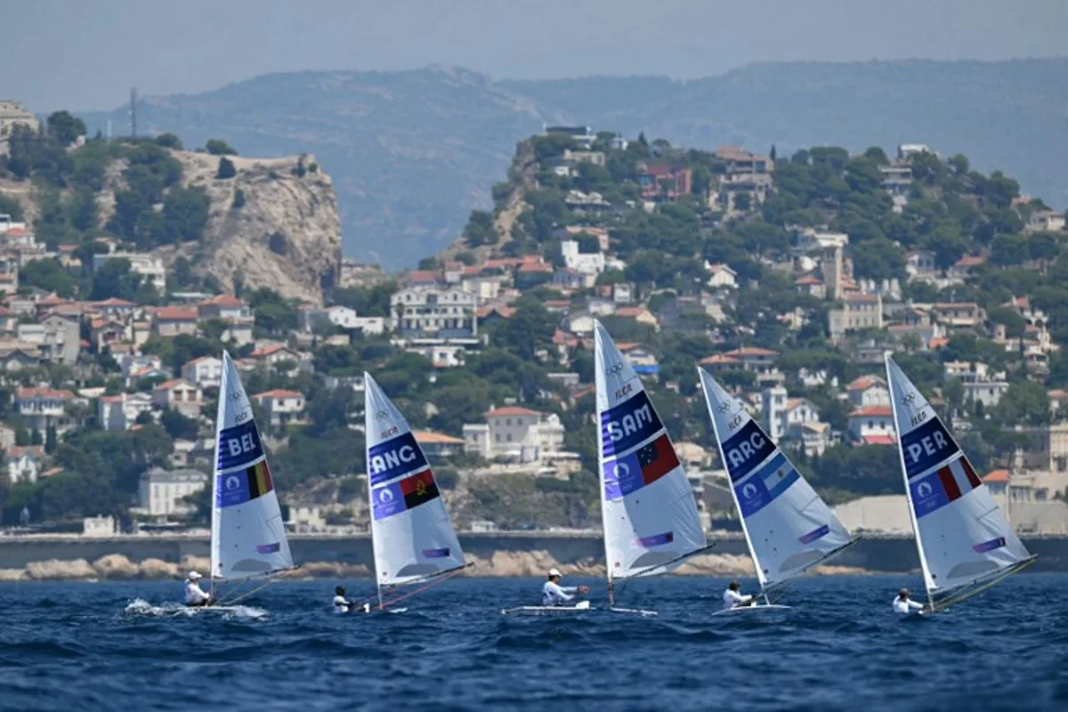 (LtoR) Belgium's William De Smet, Angola's Filipe Andre, Samoa's Eroni Leilua, Argentina's Francisco Guaragna Rigonat and Peru's Stefano Peschiera compete in race 7 of the men's ILCA 7 single-handed dinghy event during the Paris 2024 Olympic Games sailing competition at the Roucas-Blanc Marina in Marseille on August 4, 2024.   NICOLAS TUCAT / AFP